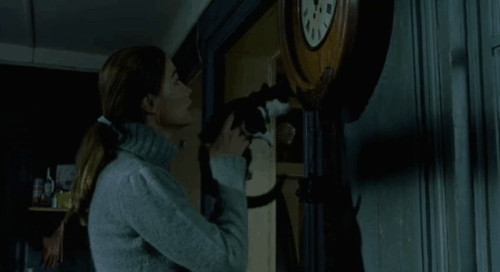 Histoire de Marie et Julien - The Story of Marie and Julien - Emmanuelle Béart with tuxedo cat Nevermore Gaspard finding items in wall clock animated gif
