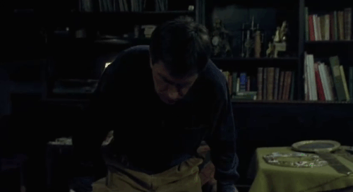 Histoire de Marie et Julien - The Story of Marie and Julien - Jerzy Radziwilowicz hugging tuxedo cat Nevermore Gaspard on lap animated gif