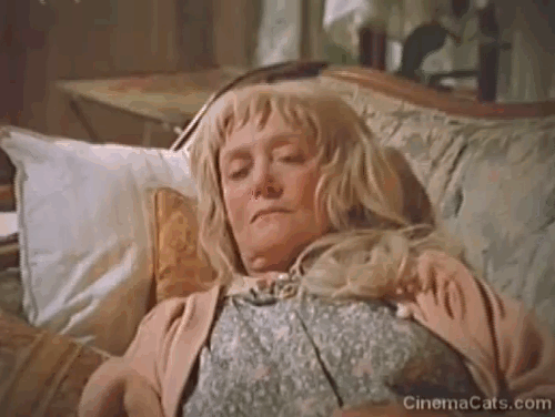 Strays - older woman Eve Brenner waking up to her numerous cats animated gif