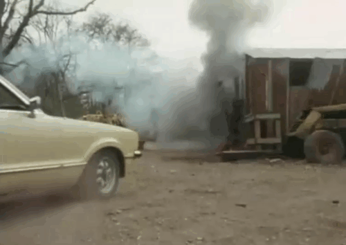 Target - The Run - tabby and white cat running away from exploding building as Bonney Brendan Price drives up animated gif
