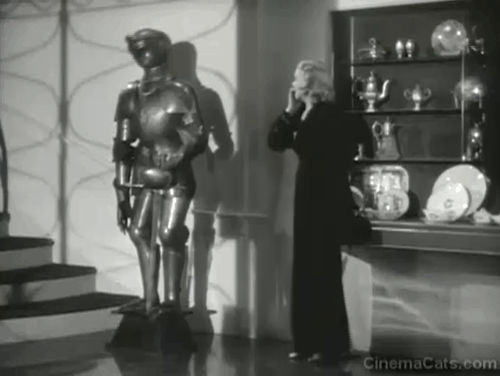 There's That Woman Again - gray and white tuxedo cat jumping down from suit of armor and scaring Sally Virginia Bruce animated gif