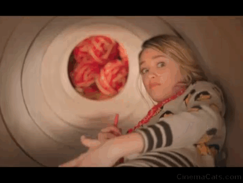 Tiny Christmas - giant Himalayan cat Tinselpaws trying to get at Barkley Lizzy Greene in wrapping tube animated gif