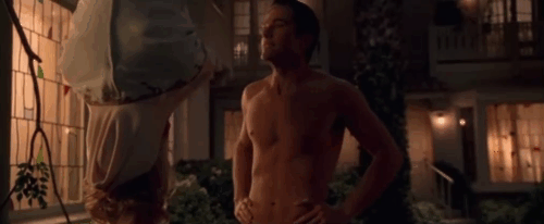 The Ugly Truth - Colin Eric Winter and brown tabby cat D'Artagnan reaching up out of camera frame animated gif