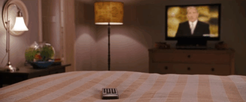 The Ugly Truth - brown tabby cat D'Artagnan jumping onto bed and turning channel on remote as Abby Katherine Heigl approaches animated gif