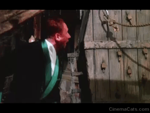 The Uncanny - Donald Pleasance chasing after orange and white tabby cat Scat Ashley with halberd animated gif