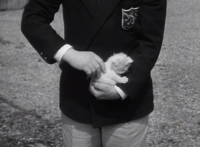 36 Hours - Orville Hart John Chandos holding bicolor tabby kitten on crook of arm