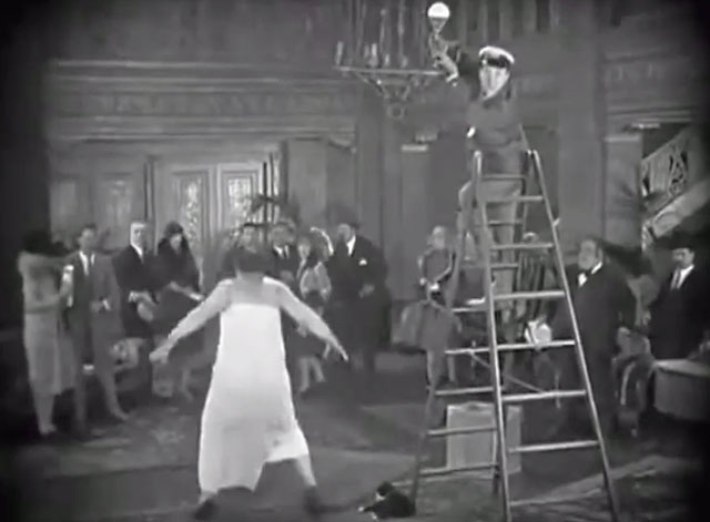 45 Minutes from Hollywood - Detective Oliver Hardy running into hotel lobby with tuxedo cat at foot of ladder