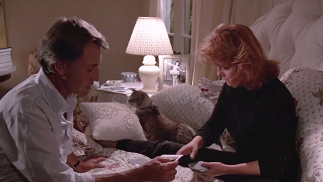 52 Pick-Up - Barbara Ann-Margret and Harry Roy Scheider sitting on bed with bicolor tabby cat