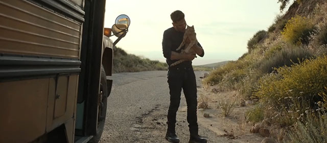 The Accountant 2 - Braxton Jon Bernthal holding ginger tabby cat in front of bus