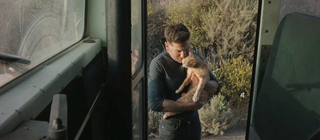 The Accountant 2 - Braxton Jon Bernthal holding ginger tabby cat outside door of bus