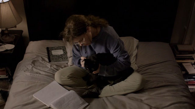 After Words - Jane Marcia Gay Harden sitting on bed with black cat