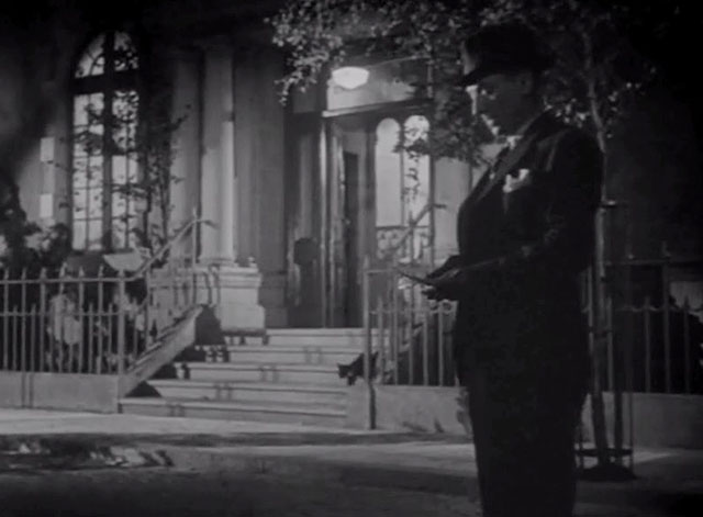 The Agitator - Pettinger outside building with tuxedo cat on steps behind