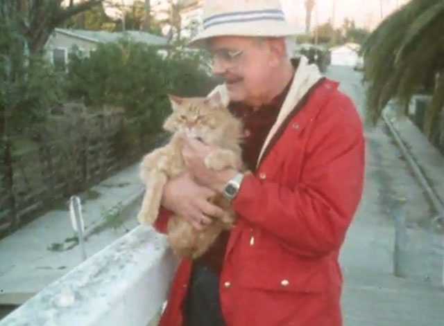 Alexander Baxter - longhair ginger tabby cat held by Mr. Baxter Edwyn Phelps on bridge