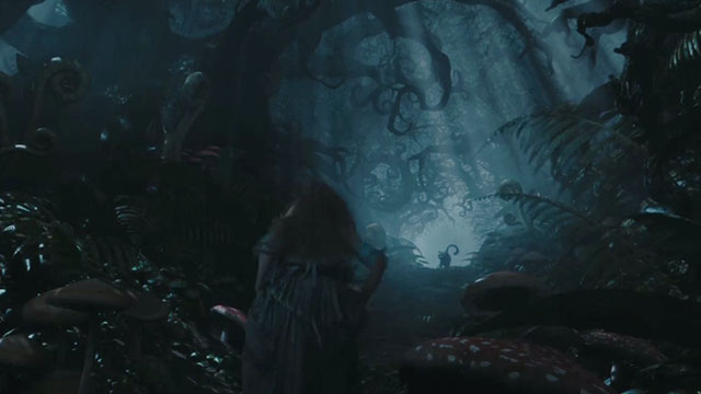 Alice in Wonderland - Cheshire Cat in distance of dark forest waiting for Alice Mia Wasikowska