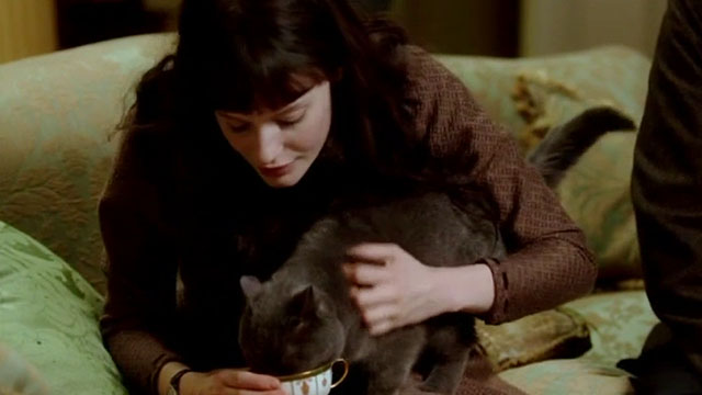 Angel - blue shorthair cat being given milk in tea cup by Romola Garai