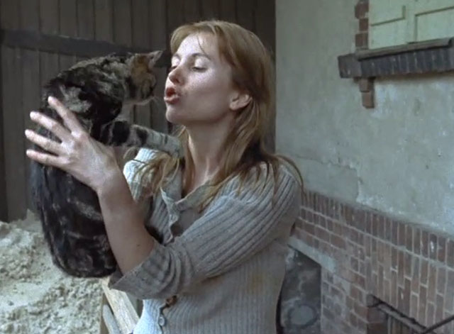Angry Harvest - Bittere Ernte - Magda Isa Haller holding up brown tabby cat