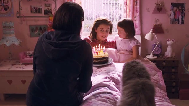 Angus, Thongs and Perfect Snogging - Smokey Persian Angus on bed as Georgia Groome is being given birthday cake by Libby Eva Drew and mom Karen Taylor
