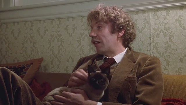 National Lampoon's Animal House - Professor Dave Jennings Donald Sutherland sitting on couch with Siamese cat on lap