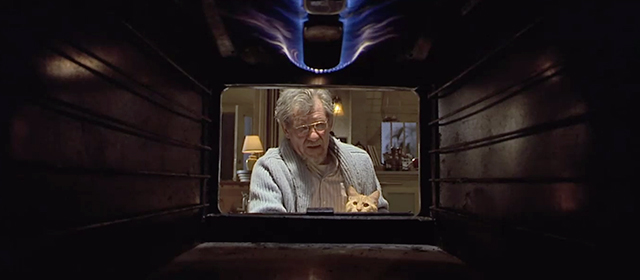 Apt Pupil - ginger tabby cat Timmy held by Kurt Dussander Ian McKellen outside oven