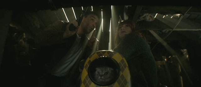 Argylle - Elly Bryce Dallas Howard with silver tabby Scottish fold cat Alfie Chip in bubble backpack and Aidan Sam Rockwell hiding under floorboards