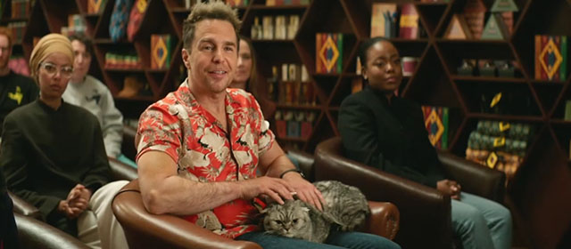 Argylle - Aidan Sam Rockwell with silver tabby Scottish fold cat Alfie Chip on lap