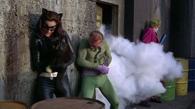 Batman the Movie - Catwoman Lee Meriwether holding black cat Hecate as door explodes with Joker Cesar Romero and Riddler Frank Gorshin