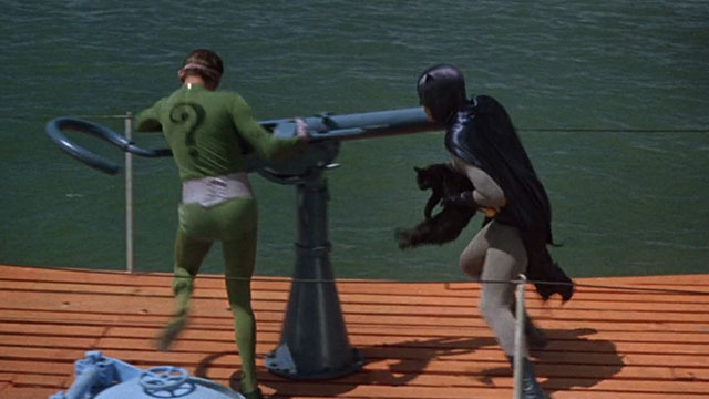 Batman the Movie - Batman Adam West holding black cat Hecate while fighting Riddler Frank Gorshin on top of submarine