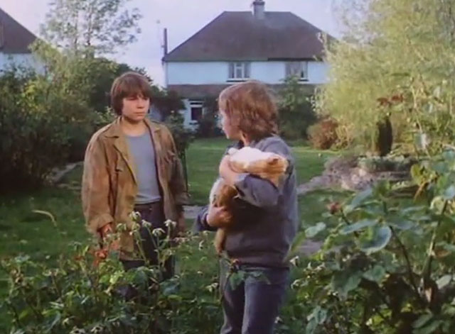 The Battle of Billy's Pond - Billy Ben Buckton holding limp young orange and white tabby cat with Gobby Andrew Ashby