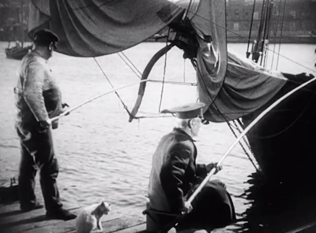 Battleship Potemkin - white cat sitting between two men fishing off dock