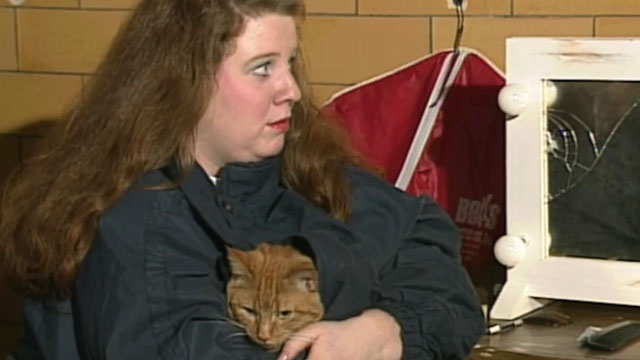Beauty Queen Butcher - Phyllis Rhona Brody holding longhair ginger tabby cat Eartha inside jacket