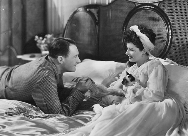 Bedelia - Bedelia Margaret Lockwood holding Siamese kitten Topaz on bed with Charlie Ian Hunter publicity still