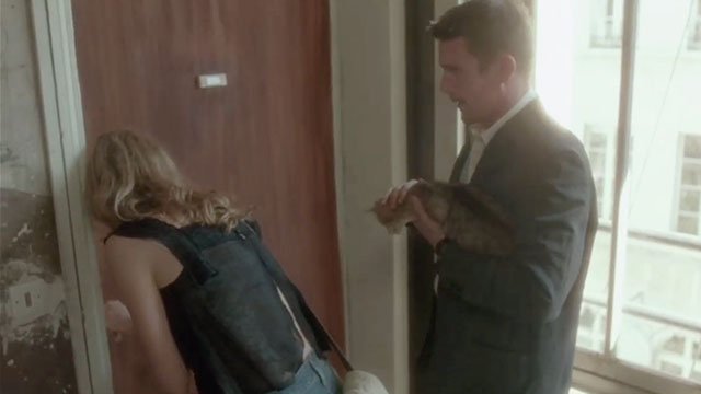 Before Sunset - tabby cat held by Jesse Ethan Hawke as Celine Julie Delpy opens door