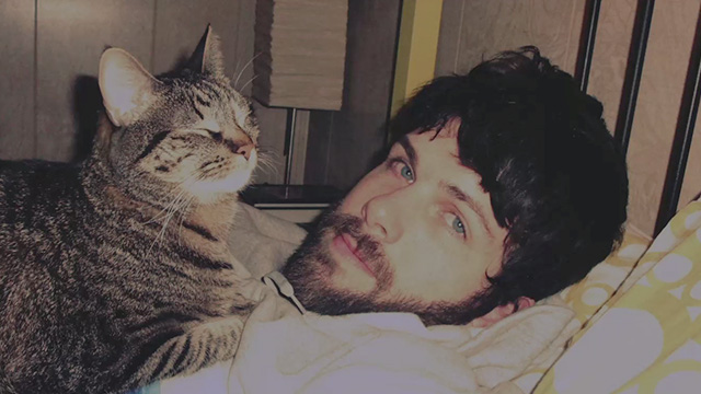 Beginners - photo of man with tabby cat on bed