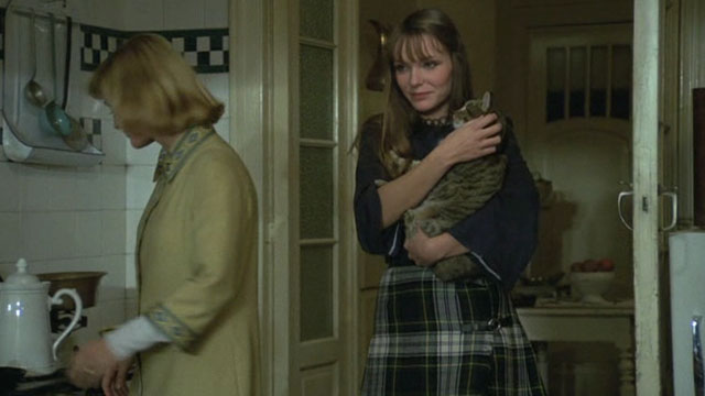 Belle - Marie Stéphane Excoffier holding brown tabby cat Juliette with Jeanne Danièle Delorme