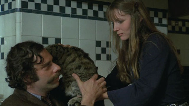 Belle - Marie Stéphane Excoffier handing brown tabby cat Juliette to Mathieu Jean-Luc Bideau