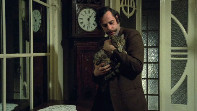 Belle - Mathieu Jean-Luc Bideau holding brown tabby cat Juliette