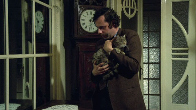 Belle - Mathieu Jean-Luc Bideau holding brown tabby cat Juliette