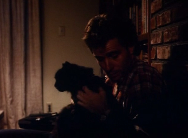 The Big Turnaround - Jim Bryan Cranston holding long-haired black cat Archibald in lap closer