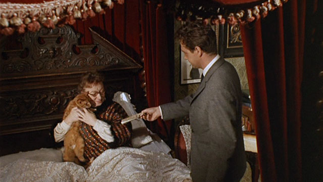 Bitter Harvest - Mrs. Jessop Thor Hird picking up ginger tabby cat in bed with Bob John Stride