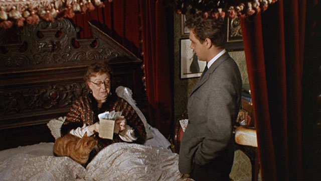 Bitter Harvest - Mrs. Jessop Thor Hird picking up ginger tabby cat in bed with Bob John Stride