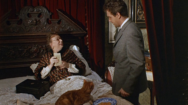 Bitter Harvest - Mrs. Jessop Thor Hird picking up ginger tabby cat in bed with Bob John Stride