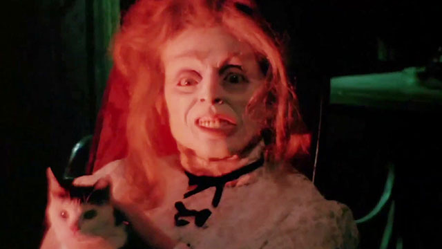 Black Sabbath - I I tre volti della paura - body of medium holding tuxedo cat in rocking chair