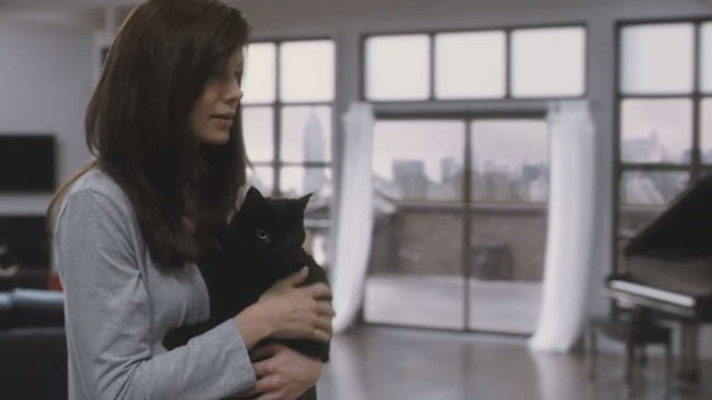 Blindsided - Sara Michelle Monaghan carrying black cat Shadow