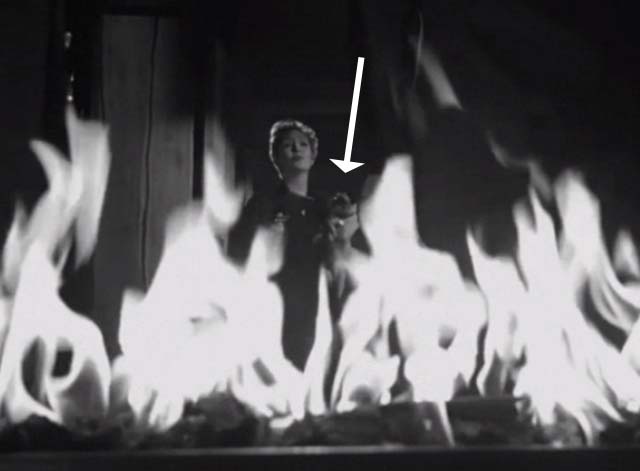 Bluebeard's Ten Honeymoons - Jeanette Jean Kent holding Siamese cat behind fire in oven