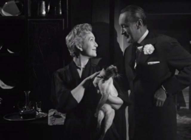 Bluebeard's Ten Honeymoons - Jeanette Jean Kent holding Siamese cat while looking at Henri George Sanders
