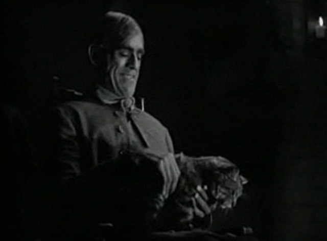 The Body Snatcher - John Gray holding tabby cat Brother on lap