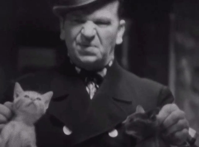 The Bowery - Connors Wallace Beery sneering at ginger and grey and white tabby kittens held by scruffs
