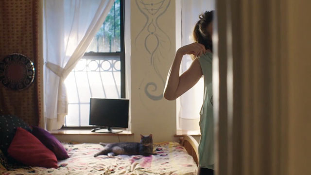 The Bracket Theory - brown tabby cat lying on bed with Lucy Meghann Fahy nearby