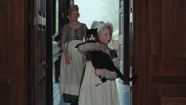 Bright Star - Toots Edie Martin carrying tuxedo cat Topper into new home