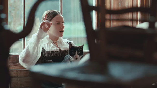 Bright Star - Fanny Abbie Cornish reading a book with tuxedo cat Topper